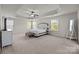 Expansive bedroom features a tray ceiling, ceiling fan, and plenty of natural light at 1300 Yellow Springs Dr, Indian Land, SC 29707
