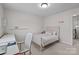 Neutral bedroom featuring a desk, chair, and cozy bed with a white comforter at 1300 Yellow Springs Dr, Indian Land, SC 29707