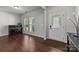 Bright entryway featuring hardwood floors, neutral walls, and natural light from the front door and window at 1300 Yellow Springs Dr, Indian Land, SC 29707