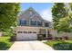 Charming two-story home with a manicured lawn, two-car garage, and inviting front porch at 1300 Yellow Springs Dr, Indian Land, SC 29707