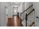Hallway view showcases the hardwood flooring, staircase, and front door, adding to the home's charm at 1300 Yellow Springs Dr, Indian Land, SC 29707