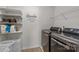 Well-organized laundry room with modern washer and dryer and ample shelving for storage at 1300 Yellow Springs Dr, Indian Land, SC 29707