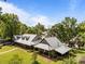 Aerial view of the sprawling property showcasing a house with mature trees and lake frontage at 1433 Kern Carlton Rd, Salisbury, NC 28146
