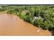 Stunning aerial view of a home on the lake surrounded by lush greenery, featuring a private dock at 1433 Kern Carlton Rd, Salisbury, NC 28146