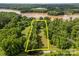 Aerial view highlighting the property lines of a large lot surrounded by lush greenery and waterfront access at 1433 Kern Carlton Rd, Salisbury, NC 28146