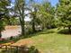 Lush backyard featuring mature trees, well-maintained grass, and a glimpse of the waterfront at 1433 Kern Carlton Rd, Salisbury, NC 28146