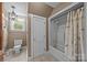 Bathroom with a tub/shower combo, toilet, and window at 1433 Kern Carlton Rd, Salisbury, NC 28146
