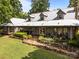 Exterior showing a metal roof, dormer windows, and wrap-around porch with manicured landscaping at 1433 Kern Carlton Rd, Salisbury, NC 28146