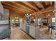 Open-concept kitchen features stainless steel appliances, granite countertops, and wood-paneled walls at 1433 Kern Carlton Rd, Salisbury, NC 28146
