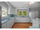 Kitchen featuring white cabinets, light blue countertops, and hardwood floors at 1433 Kern Carlton Rd, Salisbury, NC 28146