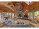 Cozy living room featuring wood walls, a stone fireplace, and an adjacent dining area at 1433 Kern Carlton Rd, Salisbury, NC 28146
