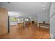 Open concept living room with wood floors, kitchen, bar, and dining area at 1433 Kern Carlton Rd, Salisbury, NC 28146