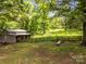 Exterior shot of outbuilding with fenced enclosure, perfect for a hobby farm or storage at 1433 Kern Carlton Rd, Salisbury, NC 28146