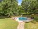 Backyard pool with a slide, lounge chairs and shaded patio area for outdoor entertaining at 1433 Kern Carlton Rd, Salisbury, NC 28146