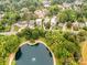 Beautiful aerial view of the neighborhood with lush greenery and a serene pond with a fountain at 1600 Princeton Ave, Charlotte, NC 28209