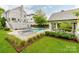 Backyard featuring an in-ground pool and spa, patio with an outdoor kitchen, and lush landscaping at 1600 Princeton Ave, Charlotte, NC 28209
