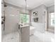 Modern bathroom boasting a glass enclosed shower, freestanding tub, and marble accents at 1600 Princeton Ave, Charlotte, NC 28209