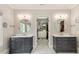 Bright bathroom featuring dual vanities and a door into a walk-in closet at 1600 Princeton Ave, Charlotte, NC 28209