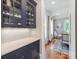 Charming butler's pantry showcases a glass cabinet, countertops, and seamless transition to dining at 1600 Princeton Ave, Charlotte, NC 28209