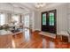 Elegant dining room area with hardwood floors, double doors, and a view of the front entrance at 1600 Princeton Ave, Charlotte, NC 28209