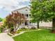 Stunning two-story home with a manicured lawn, beautiful landscaping, and charming double front porches at 1600 Princeton Ave, Charlotte, NC 28209