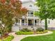 Charming two-story home with a fountain, landscaped yard, and inviting double-decker front porch at 1600 Princeton Ave, Charlotte, NC 28209