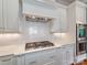 Modern kitchen featuring stainless steel appliances, sleek white cabinets, and backsplash at 1600 Princeton Ave, Charlotte, NC 28209