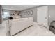 Well-lit living room boasts marble floors, a comfortable couch, and decorative wall art at 1600 Princeton Ave, Charlotte, NC 28209