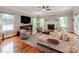 Inviting living room with a fireplace, plush seating, and hardwood floors bathed in natural light from surrounding windows at 1600 Princeton Ave, Charlotte, NC 28209