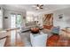 Bright living room with hardwood floors, comfortable seating, and a doorway to the staircase at 1600 Princeton Ave, Charlotte, NC 28209