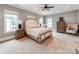 Calm main bedroom with neutral tones, carpet floors, with bright, natural light from multiple windows at 1600 Princeton Ave, Charlotte, NC 28209