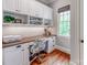Bright office space features custom built-ins, window views, and desk at 1600 Princeton Ave, Charlotte, NC 28209