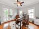 Well-appointed office features a rustic wood desk, leather chair, and lots of light at 1600 Princeton Ave, Charlotte, NC 28209