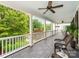 Expansive covered porch boasts ample seating with verdant tree-lined scenery at 1600 Princeton Ave, Charlotte, NC 28209