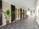 Spacious covered porch boasting black shutters, elegant decor, and exterior access at 1600 Princeton Ave, Charlotte, NC 28209
