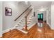 Elegant staircase features wood handrails, carpet runner, and leads to the upper level at 1600 Princeton Ave, Charlotte, NC 28209