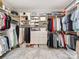 Large walk-in closet with custom shelving, ample storage and carpet at 1600 Princeton Ave, Charlotte, NC 28209