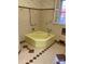 A colorful vintage bathroom including yellow fixtures and patterned tiling at 1614 Statesville Blvd, Salisbury, NC 28144