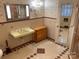 A vintage bathroom features a vanity, patterned tiling, and mirrored medicine cabinet at 1614 Statesville Blvd, Salisbury, NC 28144