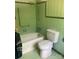 A green tiled bathroom features a tub, toilet and shower with a marble curtain at 1614 Statesville Blvd, Salisbury, NC 28144