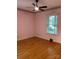Cozy bedroom with hardwood floors, ceiling fan, and a window offering natural light at 1614 Statesville Blvd, Salisbury, NC 28144