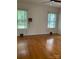 Bright bedroom featuring hardwood floors and large windows, ready for personalization at 1614 Statesville Blvd, Salisbury, NC 28144