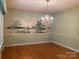 Spacious dining room with a beautiful chandelier and scenic mural at 1614 Statesville Blvd, Salisbury, NC 28144