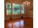 Spacious dining room with a beautiful chandelier and scenic mural, and large windows at 1614 Statesville Blvd, Salisbury, NC 28144
