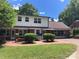 Two-story home with a brick and siding exterior, well-manicured lawn, and a paved pathway leading to the entrance at 1614 Statesville Blvd, Salisbury, NC 28144