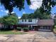 Well-maintained house with brick and siding exterior, an attached garage, and a spacious circular driveway at 1614 Statesville Blvd, Salisbury, NC 28144