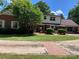 Charming two-story brick home with lush green lawn and mature trees at 1614 Statesville Blvd, Salisbury, NC 28144