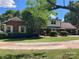 Charming two-story brick home with lush green lawn and mature trees at 1614 Statesville Blvd, Salisbury, NC 28144