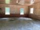 Spacious garage featuring paneled walls, brick accents, and natural light from multiple windows at 1614 Statesville Blvd, Salisbury, NC 28144
