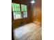 Room featuring wood paneling, hardwood floors, and bright windows at 1614 Statesville Blvd, Salisbury, NC 28144